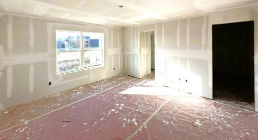 Pardon the mess! Home under construction. Primary bedroom with private ensuite bathroom and walk-in closet. *Picture is of actual home.