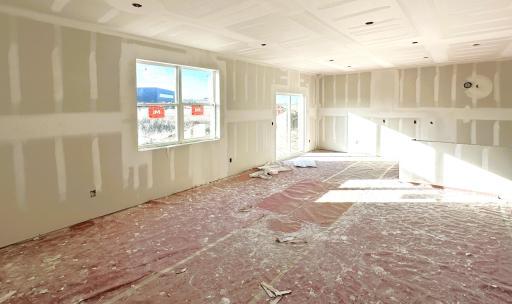 Pardon the mess! Home under construction. View of the main level from the living room towards the kitchen and dining room. *Picture is of actual home.