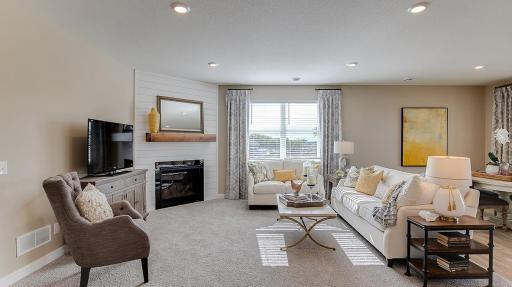 Cozy family room brings in great lighting and flexible space for furniture. Model photo. Options and colors will vary. See listing agent for home specific selections.