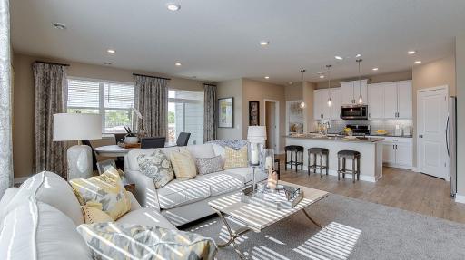 Another great view of the openness of your main level home with an inflow of lighting from all directions! Model photo. Options and colors will vary. See listing agent for home specific selections.