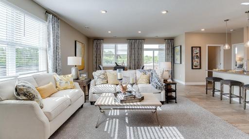 Another great view of the openness of your main level home with an inflow of lighting from all directions! Model photo. Options and colors will vary. See listing agent for home specific selections.