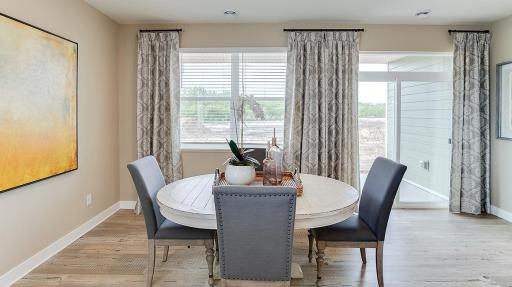 Informal dinette gives you space for a circular table, as pictured, or a longer more formal dining set. Model photo. Options and colors will vary. See listing agent for home specific selections.