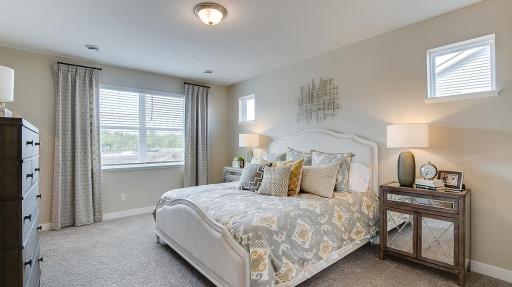 Primary bedroom includes all featured windows to give extra lighting while still maintaining privacy. Model photo. Options and colors will vary. See listing agent for home specific selections.