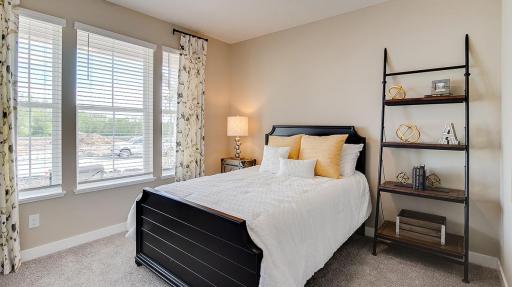 Front bedroom of the home is flooded with natural lighting! Model photo. Options and colors will vary. See listing agent for home specific selections.