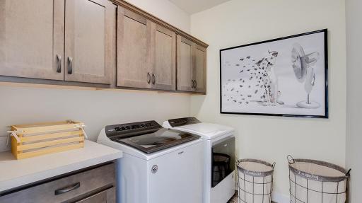 Large laundry room gives you space to wash, dry, fold, iron and for extra storage needs! Model photo. Options and colors will vary. See listing agent for home specific selections.