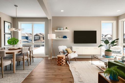 Main level family room, dining and kitchen will reflect the upgraded SPC flooring. The Stone Polymer Composite flooring is beautiful and durable. Photo is of similar floorplan; options and features will vary.