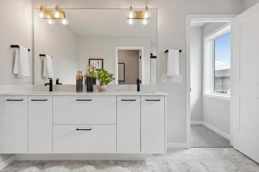 Beautiful vanity with extra tall mirror with light fixtures in the mirror.