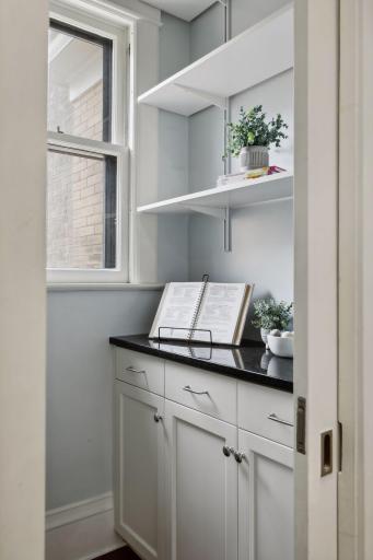 A pantry with a sliding door is perfect for that necessary additional storage.