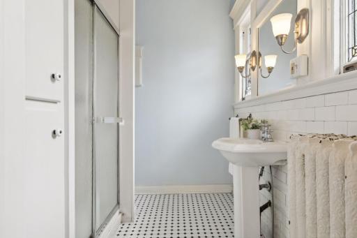 As well as its ow renovated bath complete with a walk-in shower and pedestal sink, darling tile floor and water closet.