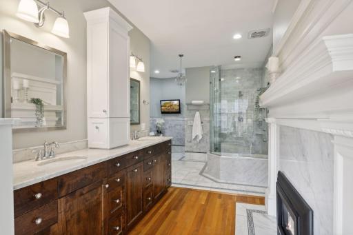 Complete with Walnut cabinetry, quartz counters, a gas fireplace, marble step in spa shower, jacuzzi bath and water closet, everything about this owners suite bath will make your heart sing.