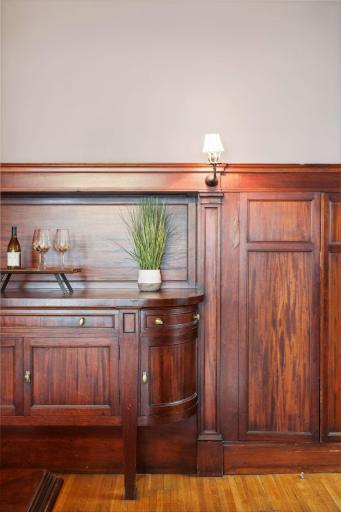 The original restored dining hutch molds into the wall organically and beautifully like a piece of art.