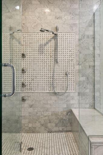 The floor to ceiling custom tile is stunning. Every amenity was considered in this shower design.