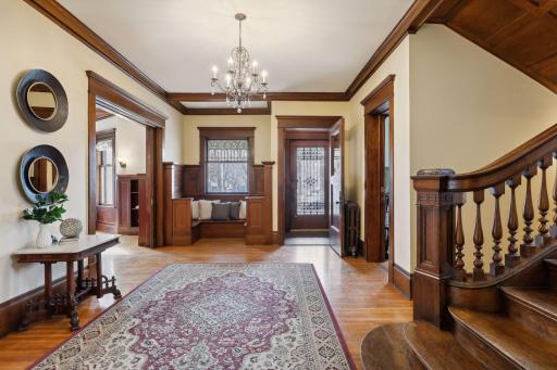 Sunlight dances through stained and leaded glass windows, casting a warm glow upon the original hardwood floors.