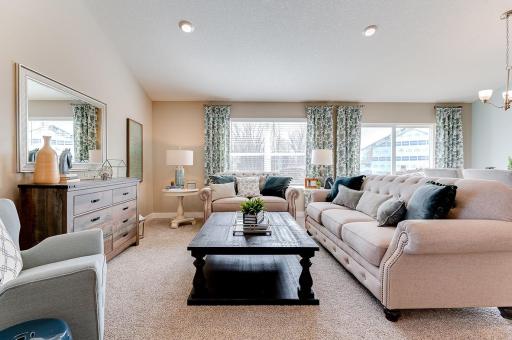 Open concept living with vaulted ceilings on the spacious main level. *Photo is of a previous model home. Colors and selections shown will vary.
