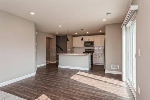 Photo for 10618 Weston Way N, Maple Grove, MN 55369 - Listing #6478866 This spacious plan offers plenty of spaces to gather, offering the opportunity to have seating both at the island as well as accommodating a dining room table. *Photos are of another home, colors and finishes will vary.