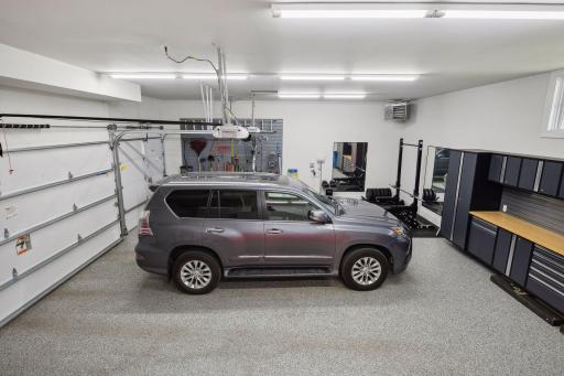 Heated 3-car garage with epoxy floor and lot of storage