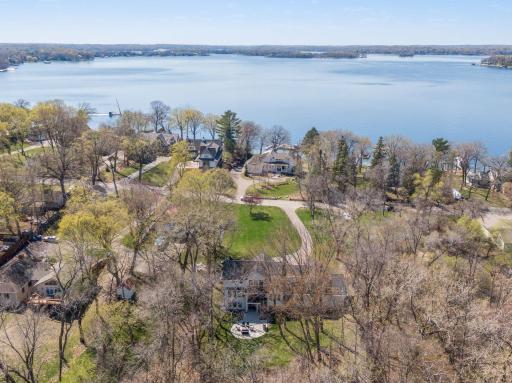 Aerial view looking over front yard out to the lake