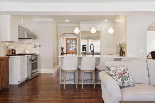 The well-appointed eat-in kitchen features custom cabinetry, stainless-steel appliances and a pantry.