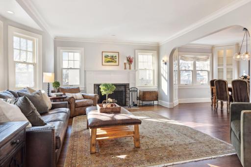 Step into the inviting living room with espresso-stained hardwood floors leading to the adjacent formal dining room.
