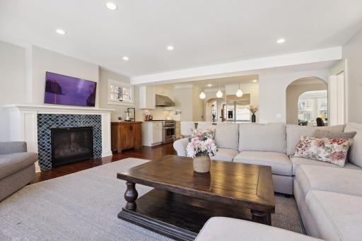 The family room features a gas fireplace and wall of windows.