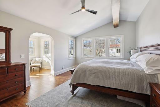 Retreat to the upper-level primary bedroom suite with a sunroom and luxurious bathroom.