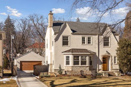 The gated driveway leads to a fenced backyard, patio and a two-car garage.