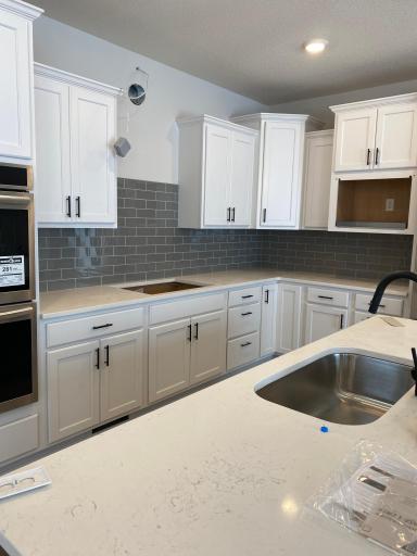 Gourmet kitchen with gas cooktop, stainless steel hood and double ovens!