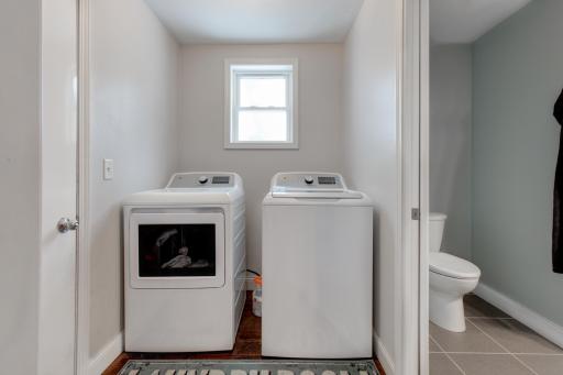 Functional laundry room space between the bathroom, kitchen, and double-stall garage