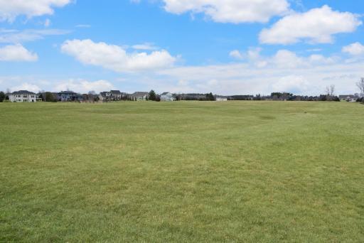Over an acre-sized lot with panoramic views of the driving range. This is the view out the backside of the property.