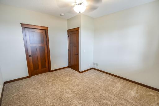 Bedroom #4 in lower level with ceiling light/fan, carpet.