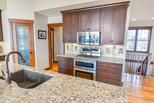 Cook center central with microwave, gas range and double ovens.