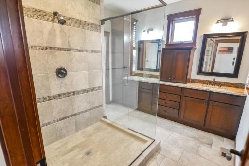 Large glass enclosed shower in Owner's private bath.