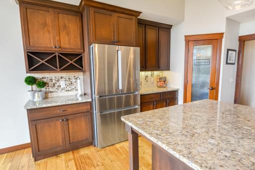 Walk-in pantry, tiled backsplash and quartz countertops.