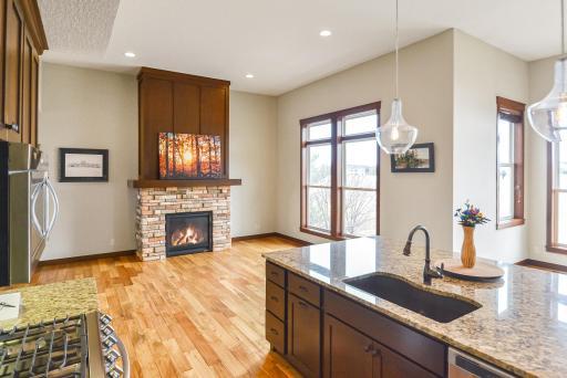 Main-level living area with cozy gas fireplace and built-in TV behind the painting.