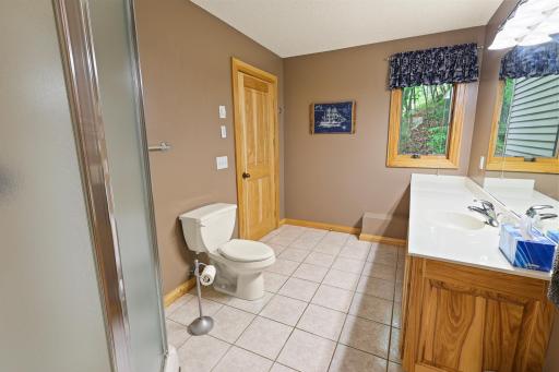 Another view of the main level bath. The home offers In-Floor heat in the kitchen, three main bathroom and the garage.