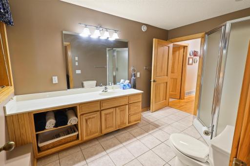 Spacious main floor walk-though bathroom with ceramic tile.