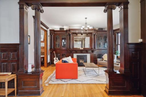 A grand entryway with columns leads to the living room.