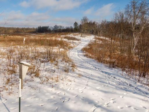 Wildlife galore, trails, grassland and majestic Minnesota Lakes encompass this property.