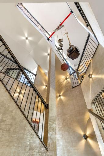 There are extravagant light fixtures, ceiling artwork, fans and hanging sculptures throughout.