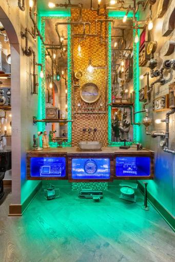 The remarkable main floor half bath is filled with steampunk dÃ©cor and mood lighting.