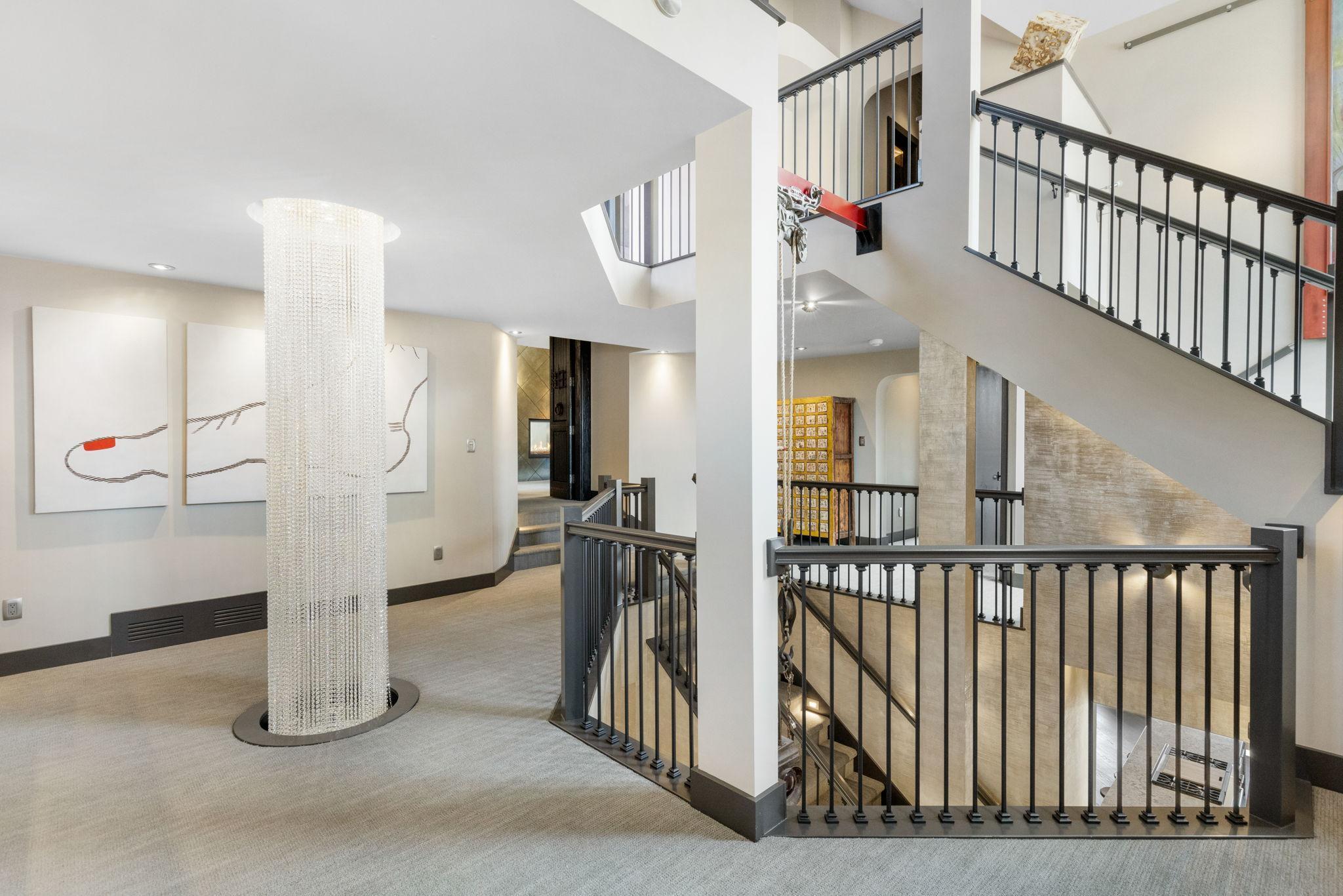 The second level features a large loft art gallery space with lighted display alcoves.