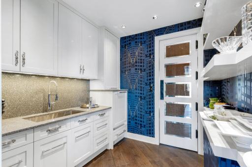 A spacious butlerâs pantry with abundant storage, shelving, an additional dishwasher and large sink
walks through to the formal dining from the kitchen.