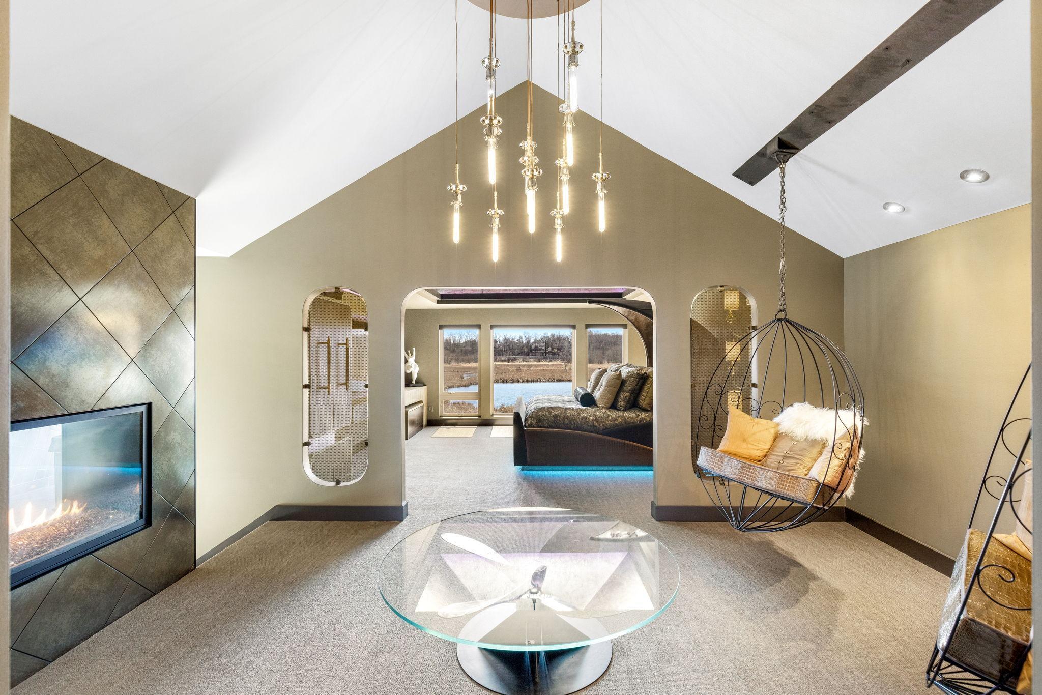 The extraordinary primary wing features a spacious bedroom with stunning views & an adjoining sitting room, an incredible indoor/outdoor hot tub room, an enormous walk-in closet & dressing room, private gym, and luxurious spa-like bathroom.