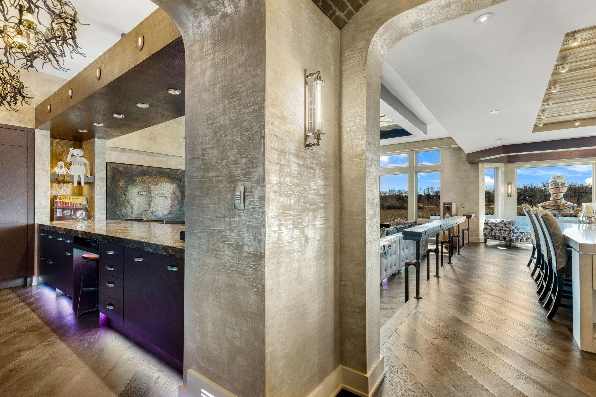 The spacious and open concept living room overlooks the stunning property or the theater style, drop-down projection screen.