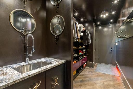 A generous mudroom with a large sink and convenient, built-in, lighted shoe storage leads you to the upper level garage.