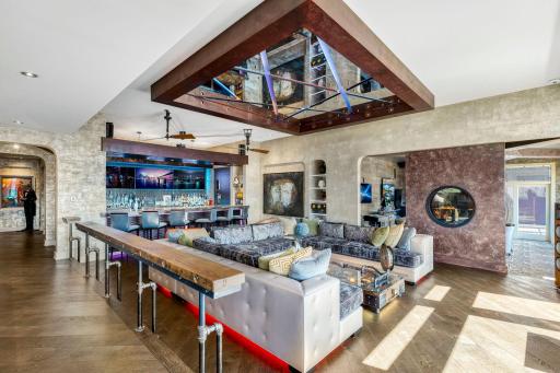 The spacious and open concept living room overlooks the stunning property or the theater style, drop-down projection screen.
screen