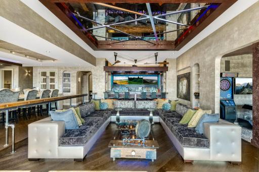 The spacious and open concept living room overlooks the stunning property or the theater style, drop-down projection screen.