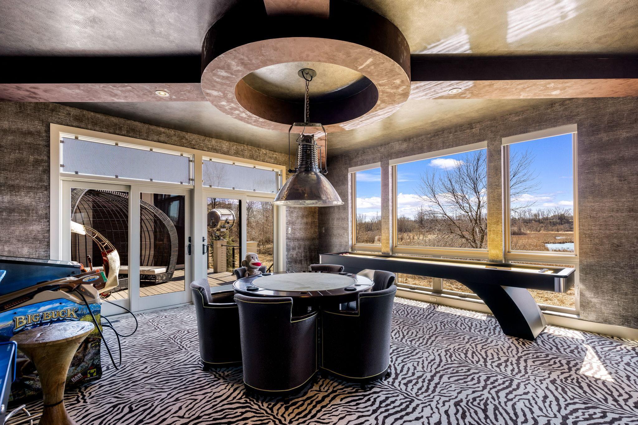 The sun filled game room walks out to a private deck overlooking the vast estate.