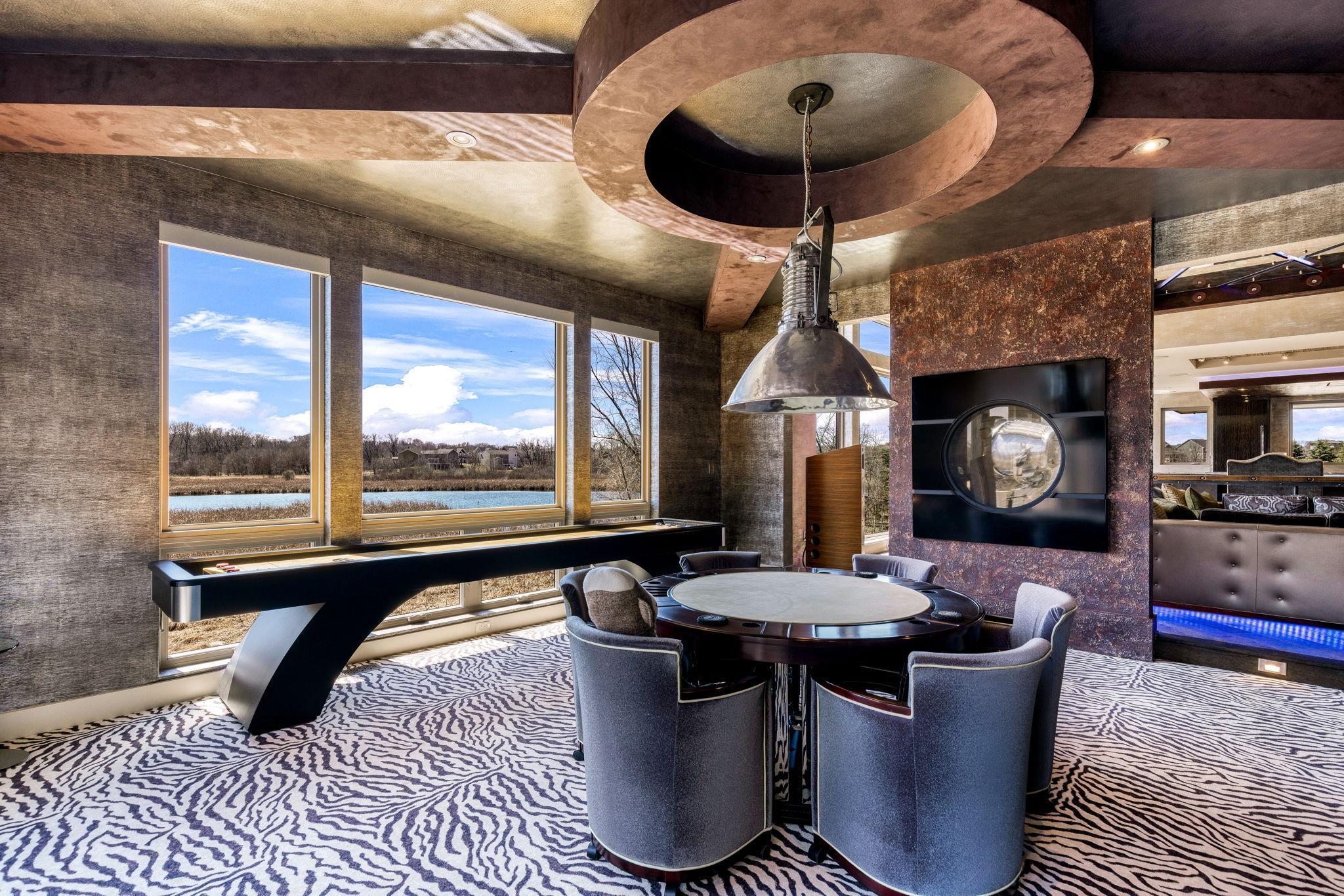 The sun filled game room walks out to a private deck overlooking the vast estate.