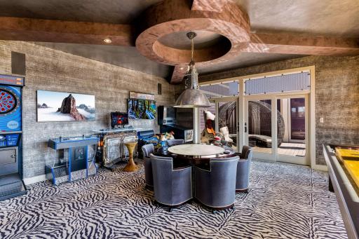 The sun filled game room walks out to a private deck overlooking the vast estate.